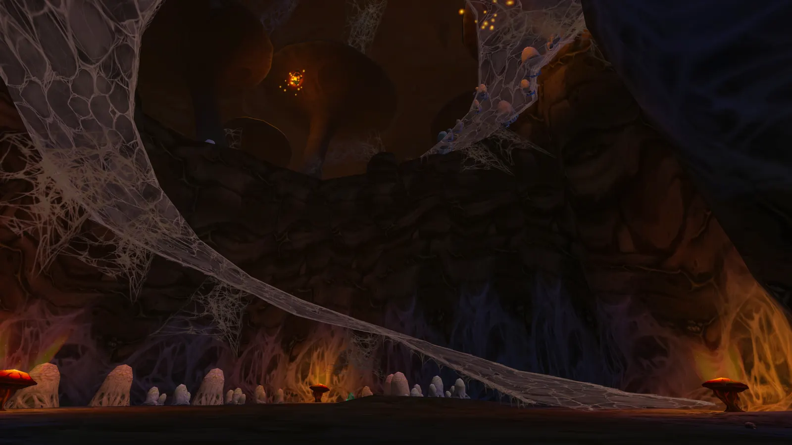 Webs and fire light in a cavern of the Barrow Deeps raid
