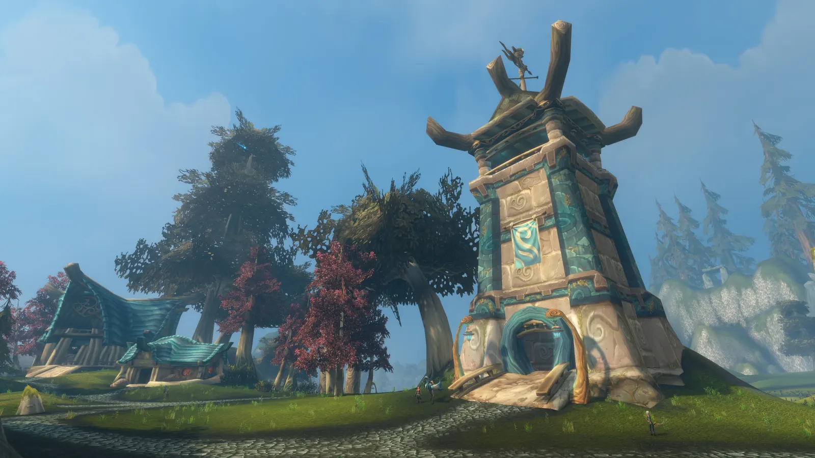 A carved stone tower with a winged crest among red leaved trees on Zephras Isle